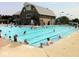 Large community pool with many residents swimming and enjoying the amenities at 244 W Admiral S Way, Carmel, IN 46032