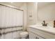 Well-lit bathroom featuring a white vanity, sleek black faucet, and patterned shower curtain at 2548 Ruffian Dr, Westfield, IN 46074