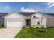 Charming one-story home with a manicured lawn, attached garage, and American flag, exuding curb appeal at 2548 Ruffian Dr, Westfield, IN 46074