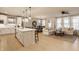 Open-concept kitchen, dining, and living area with hardwood floors and ample natural light at 2548 Ruffian Dr, Westfield, IN 46074