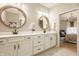 Bright bathroom with double vanity, modern mirrors, and neutral tile at 2548 Ruffian Dr, Westfield, IN 46074