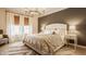 Cozy main bedroom with decorative chandelier, bedside tables and comfortable bedding at 2548 Ruffian Dr, Westfield, IN 46074