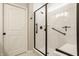 Tiled shower with shower bench and glass door at 2548 Ruffian Dr, Westfield, IN 46074