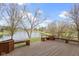 Inviting backyard deck with built-in seating, offering serene views of the tranquil pond and lush landscaping at 300 Wyndotte Dr, Carmel, IN 46032