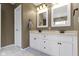 Bathroom with double sink vanity, decorative mirrors, and marble flooring at 300 Wyndotte Dr, Carmel, IN 46032