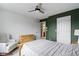Cozy bedroom with natural light, ceiling fan, chair and views of the en suite bathroom at 300 Wyndotte Dr, Carmel, IN 46032