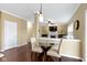 Dining area with a modern glass table and chairs, hardwood floors, and modern lighting at 300 Wyndotte Dr, Carmel, IN 46032