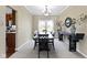 Formal dining room with elegant chandelier and large window for ample natural light at 300 Wyndotte Dr, Carmel, IN 46032