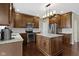 Updated kitchen featuring stainless appliances, an island with granite counters, and hardwood floors at 300 Wyndotte Dr, Carmel, IN 46032