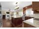 Open concept kitchen and living area with hardwood floors and stone countertops at 300 Wyndotte Dr, Carmel, IN 46032