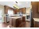 Bright kitchen features granite counters, stainless appliances, ample cabinet space, and hardwood flooring at 300 Wyndotte Dr, Carmel, IN 46032