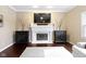 Living room featuring fireplace, hardwood flooring, and stylish decor at 300 Wyndotte Dr, Carmel, IN 46032