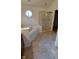 Well lit bathroom with shower, soaking tub and octagon window at 3237 Boxwood Dr, Indianapolis, IN 46227