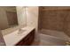 This bathroom features a vanity, mirror, and bathtub with tile surround at 3237 Boxwood Dr, Indianapolis, IN 46227