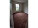 This bedroom features neutral walls, a window, and plush carpeting at 3237 Boxwood Dr, Indianapolis, IN 46227