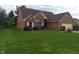 Lovely single-story brick home with a lush green lawn and mature trees at 3237 Boxwood Dr, Indianapolis, IN 46227