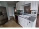 Bright kitchen features stainless steel appliances, white cabinetry, tile flooring and mosaic tile backsplash at 3237 Boxwood Dr, Indianapolis, IN 46227