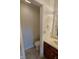 Toilet room showing commode and sink with tan tile floor at 3237 Boxwood Dr, Indianapolis, IN 46227