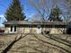 The back of the home reveals tan siding, a yard with shade, and access through the French doors at 3642 Horth Ct, Indianapolis, IN 46235