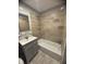 A newly renovated bathroom with a tiled shower and updated vanity is a great space for relaxing at 3642 Horth Ct, Indianapolis, IN 46235