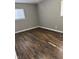 Bedroom with wood-look flooring, neutral walls, and natural light from the window at 3642 Horth Ct, Indianapolis, IN 46235