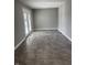 A simple bonus room awaits its new homeowner with gray paint, white trim and french doors to the outside at 3642 Horth Ct, Indianapolis, IN 46235