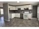 A cozy kitchen with white cabinets and gray counters with a stainless steel dishwasher awaits a new homeowner at 3642 Horth Ct, Indianapolis, IN 46235