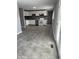 A cozy kitchen with white cabinets and gray counters with a stainless steel dishwasher awaits a new homeowner at 3642 Horth Ct, Indianapolis, IN 46235