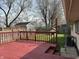 Red deck with wooden railing overlooking the backyard and shed at 3841 Monica Ct, Indianapolis, IN 46226