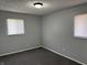 Bedroom with two windows, neutral walls, and carpet flooring at 3841 Monica Ct, Indianapolis, IN 46226