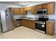 Well-equipped kitchen featuring stainless steel appliances and wooden cabinets at 3841 Monica Ct, Indianapolis, IN 46226