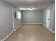 Spacious room with neutral walls, tile floor, and a white door at 3841 Monica Ct, Indianapolis, IN 46226