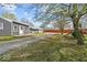 Expansive backyard featuring a playset, mature trees, and a cozy patio area with outdoor seating and a hammock at 415 Elm Ave, Sheridan, IN 46069