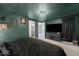 Green bedroom featuring carpet floors, a gold-tone bed frame, and modern decor, creating a stylish, relaxing space at 415 Elm Ave, Sheridan, IN 46069