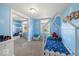 Playful bedroom with a blue and white cloud theme, featuring a charming toddler bed and bright, cheerful decor at 415 Elm Ave, Sheridan, IN 46069