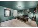 Cozy bedroom with dark green walls, a gold-tone bed frame, and unique decor, creating a stylish, relaxing space at 415 Elm Ave, Sheridan, IN 46069