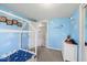 Fun bedroom featuring a toddler bed, blue cloud decor, and ample storage, creating a cheerful and organized space at 415 Elm Ave, Sheridan, IN 46069
