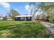 Cozy house on a spacious lot featuring a large yard, mature trees, and ample space for outdoor activities at 415 Elm Ave, Sheridan, IN 46069