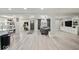 Bright and open living space with modern flooring and neutral decor, seamlessly connecting to the kitchen and dining area at 415 Elm Ave, Sheridan, IN 46069