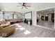 Bright living room featuring stylish flooring, a ceiling fan, and comfortable seating, perfect for relaxing and entertaining at 415 Elm Ave, Sheridan, IN 46069