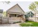 Exterior back view of the home with a covered porch and a fenced-in yard at 420 Orange St, Indianapolis, IN 46225