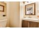 Cozy powder room features a stylish vanity with modern sink, mirror, and a decorative painting at 420 Orange St, Indianapolis, IN 46225