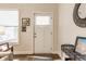 Bright entryway featuring a white door, neutral walls, hardwood floors, and decorative accents at 420 Orange St, Indianapolis, IN 46225