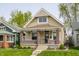 Charming bungalow-style home with a welcoming front porch, brick accents, and well-maintained lawn at 420 Orange St, Indianapolis, IN 46225
