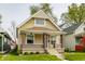 Charming bungalow-style home with a welcoming front porch, brick accents, and well-maintained lawn at 420 Orange St, Indianapolis, IN 46225