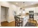 Open kitchen with island, stainless appliances, white cabinets, and hardwood floors is great for entertaining at 420 Orange St, Indianapolis, IN 46225