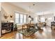 Open concept living and dining area with hardwood floors, neutral walls and a large window with a window seat at 420 Orange St, Indianapolis, IN 46225
