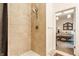 Walk-in shower with tile surround, hand-held shower head and view of bedroom, providing comfort and style at 420 Orange St, Indianapolis, IN 46225