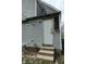 Back of the house featuring siding and a door with damaged trim at 425 N Grant Ave, Indianapolis, IN 46201