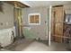 This room's walls show damage with exposed beams, with evidence of water damage, and incomplete plaster work at 425 N Grant Ave, Indianapolis, IN 46201